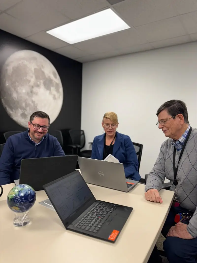 IBR scientific team collaborating at a conference table, showcasing expertise in behavioral economics research.